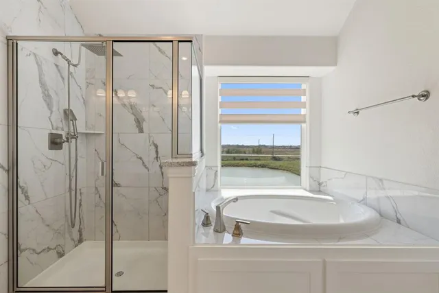 a bathroom with a bathtub and a shower