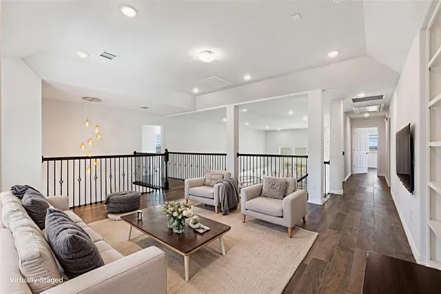 a living room with furniture fireplace and a table