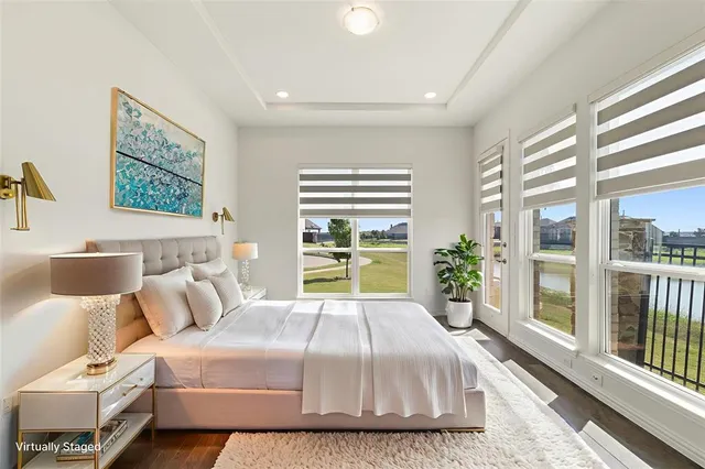 a bedroom with a large bed and a large window