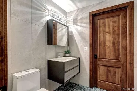 a bathroom with a toilet sink and mirror