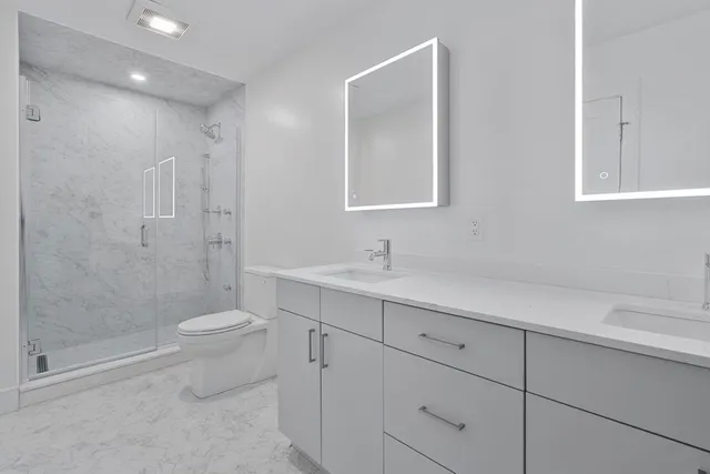 a view of bathroom with a sink toilet and shower