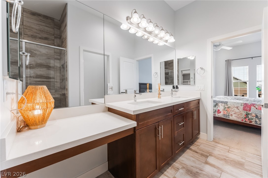 6432 Spring Jog Street Las Vegas, NV 89166 - Photo 22 of 61 Dual vanities and a spacious walk-in shower elevate this bathroom's comfort and utility.