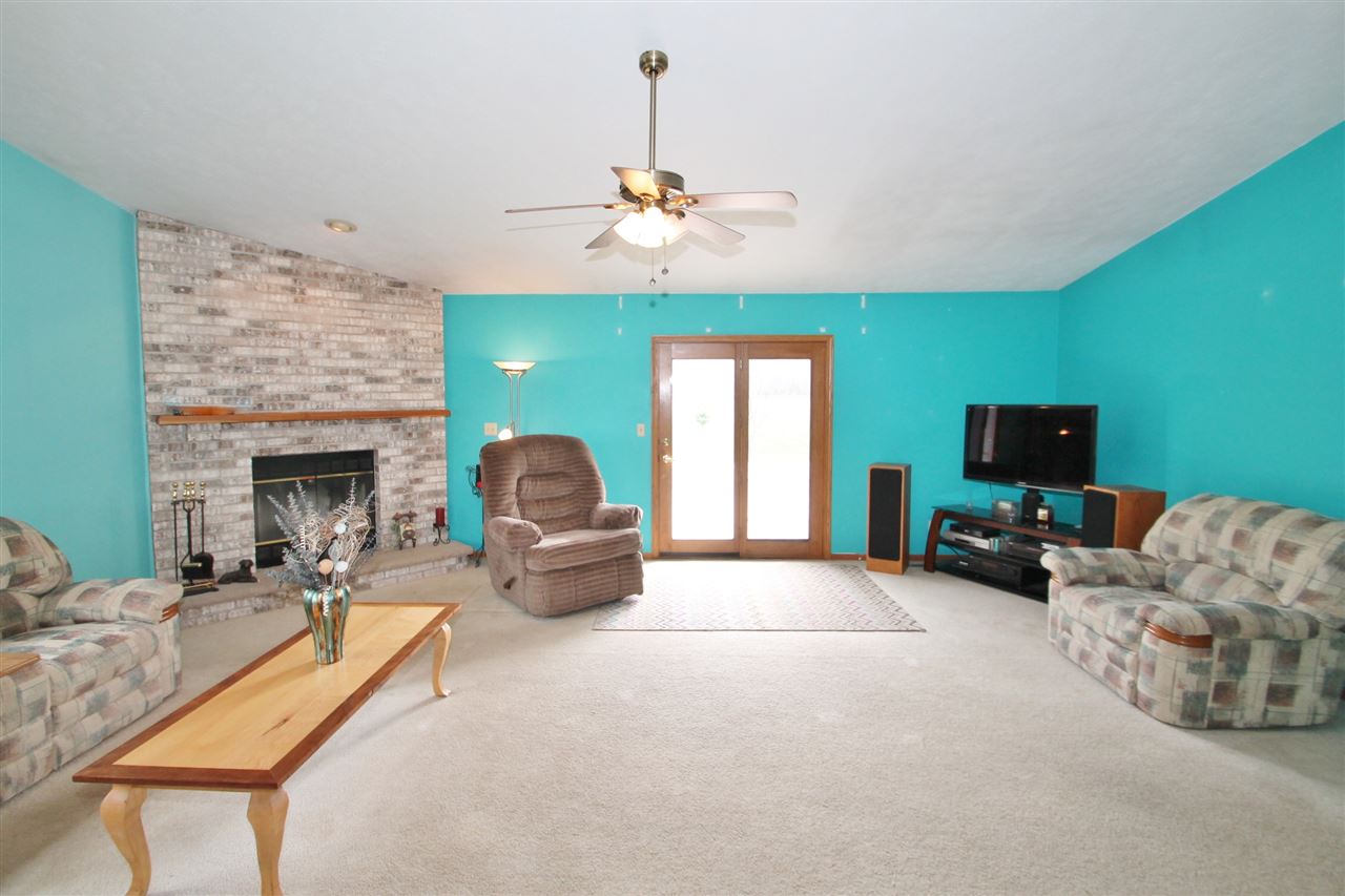 4247 Waltham Road Roscoe, IL 61073 - Photo 6 of 19 a living room with furniture and a fireplace
