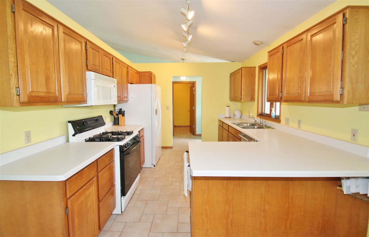4247 Waltham Road Roscoe, IL 61073 - Photo 8 of 19 a kitchen with stainless steel appliances a stove a sink and a refrigerator