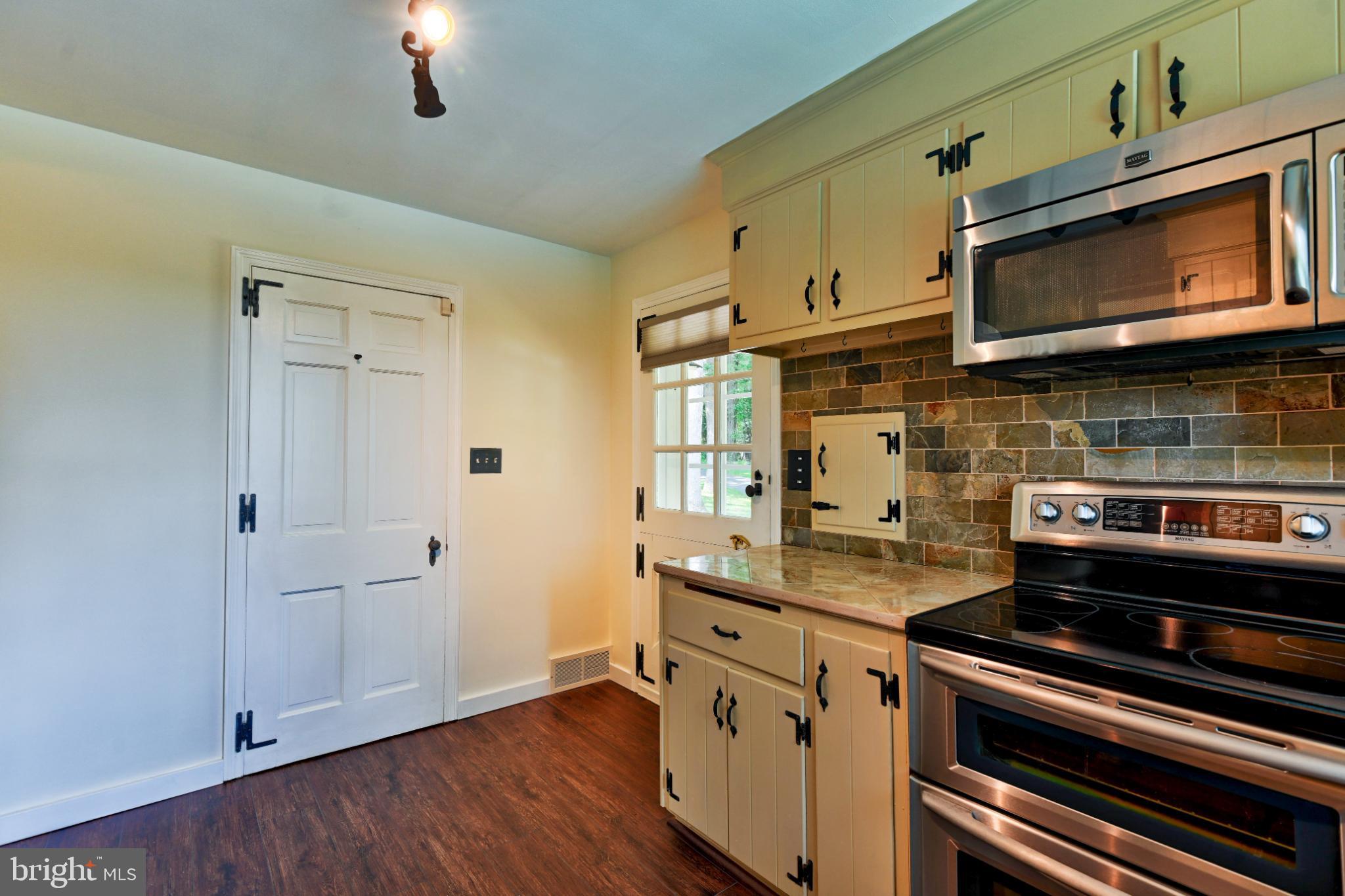 1531 North Ridge Road Perkasie, PA 18944 - Photo 3 of 30 a kitchen with stainless steel appliances a stove a microwave and cabinets