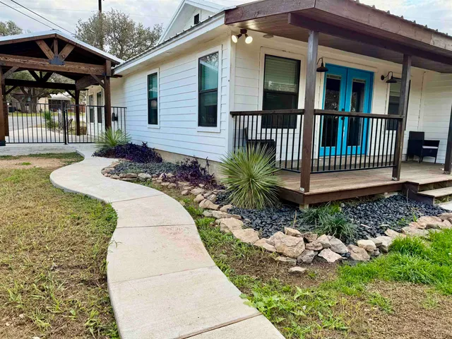 a front view of a house with garden