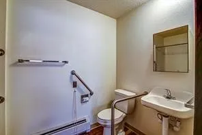 a bathroom with a sink mirror and toilet