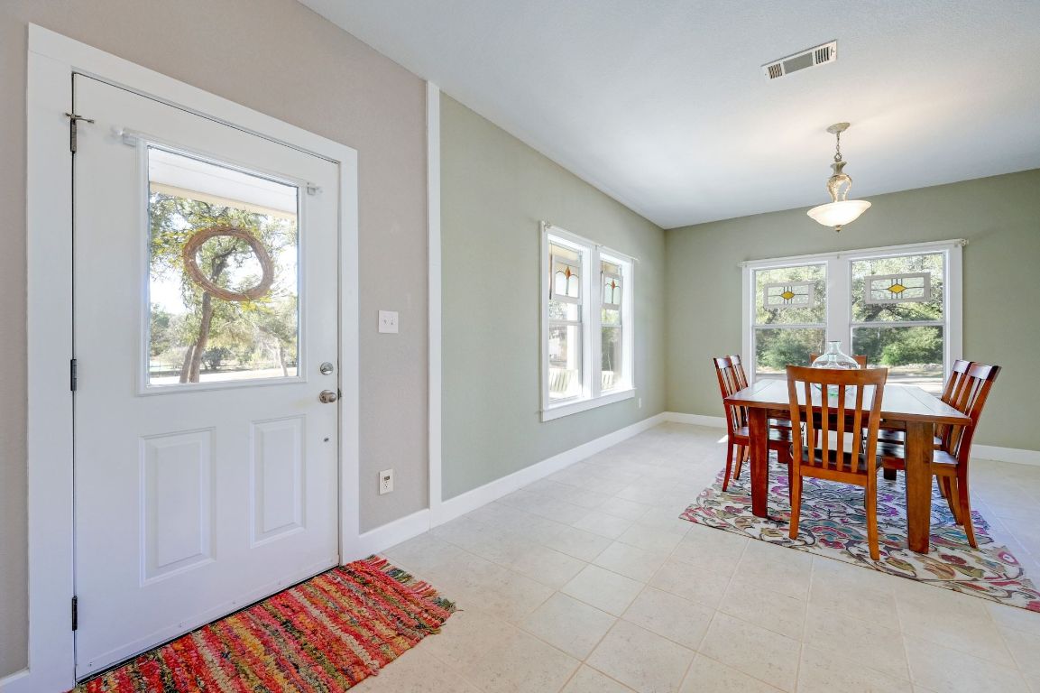 881 Saddle Ridge Drive Wimberley, TX 78676 - Photo 15 of 30 a dining room with furniture and window