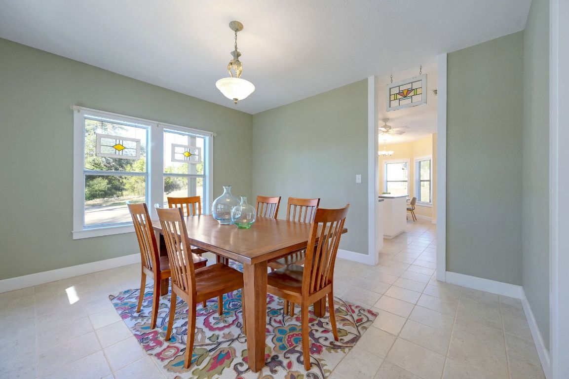 881 Saddle Ridge Drive Wimberley, TX 78676 - Photo 16 of 30 a view of a dining room with furniture and window