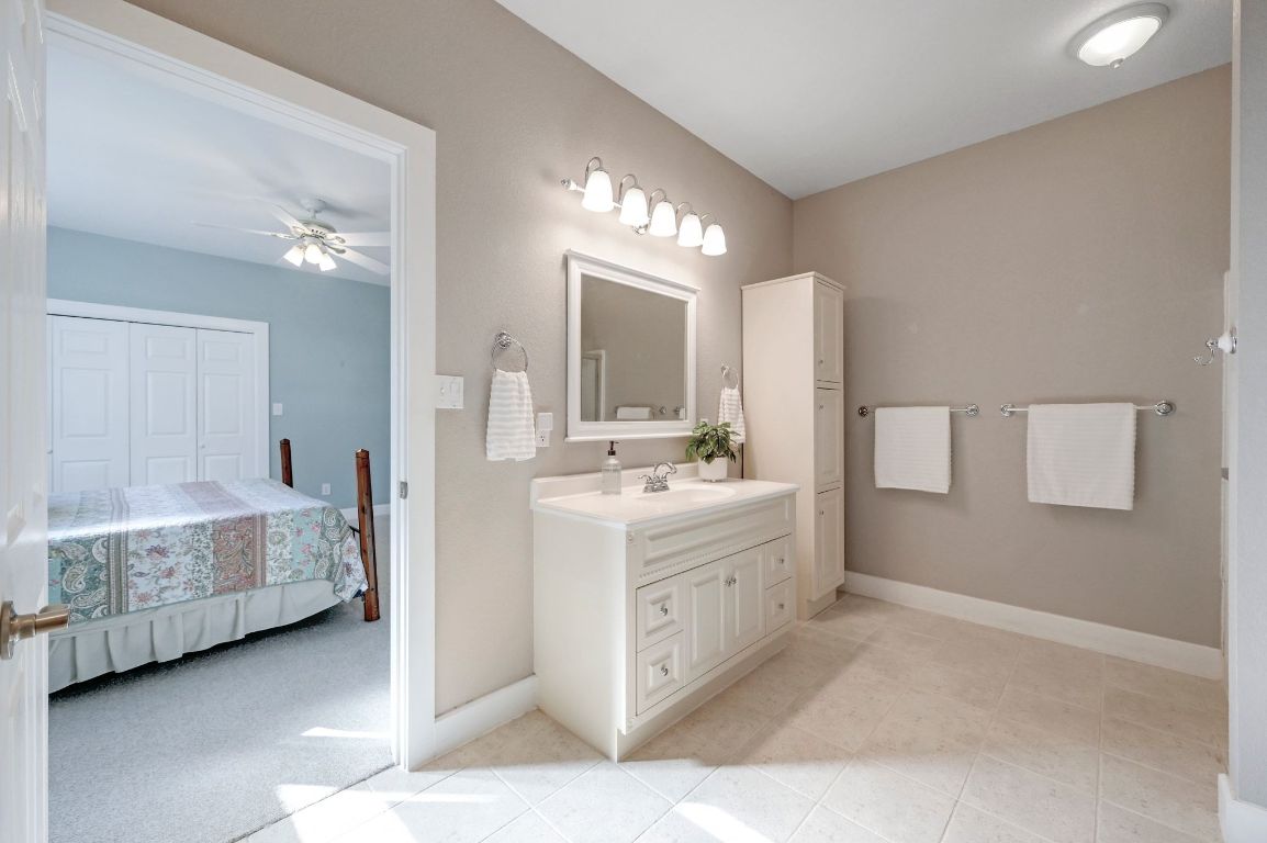 881 Saddle Ridge Drive Wimberley, TX 78676 - Photo 20 of 30 a bathroom with a double vanity sink and a mirror
