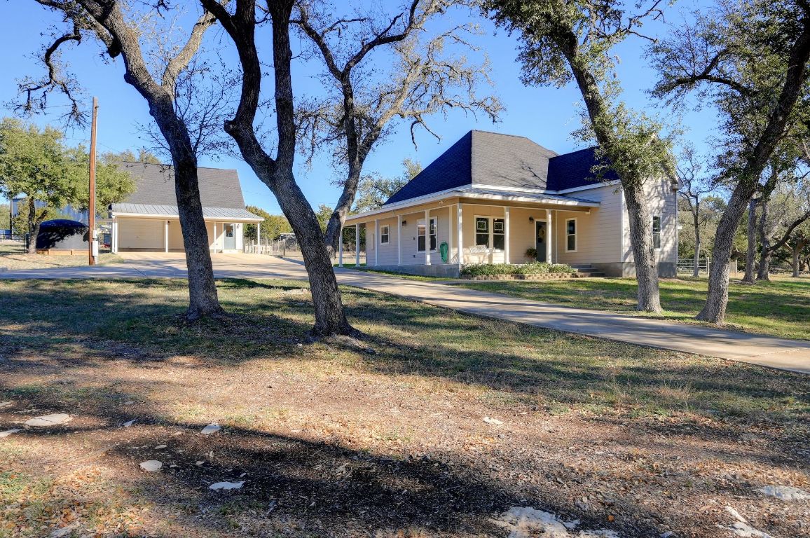 881 Saddle Ridge Drive Wimberley, TX 78676 - Photo 2 of 30 a front view of a house with a yard