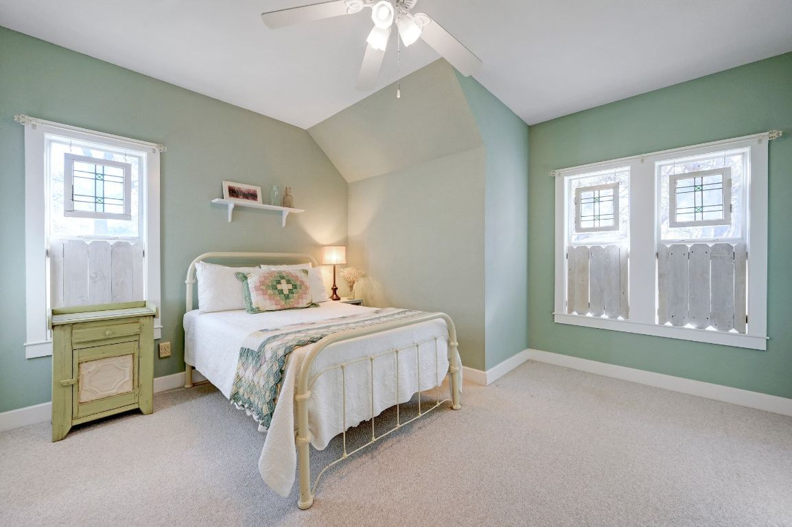 881 Saddle Ridge Drive Wimberley, TX 78676 - Photo 22 of 30 a spacious bedroom with a bed and a window