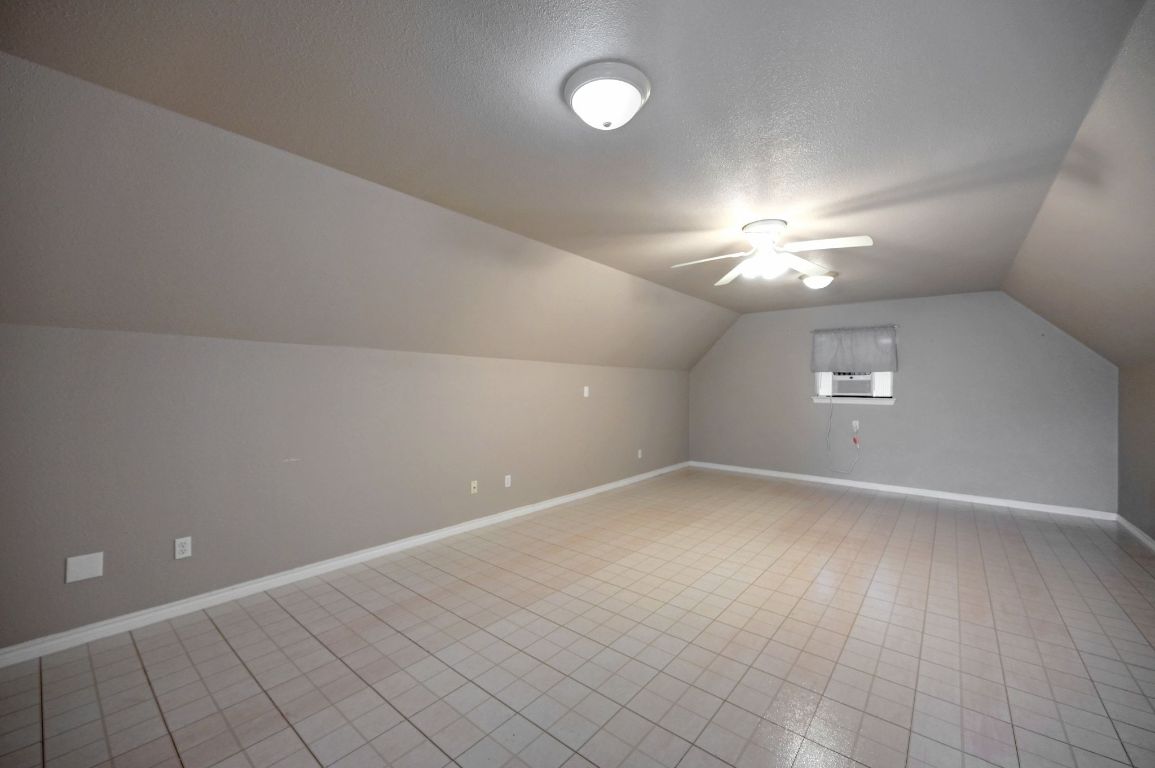 881 Saddle Ridge Drive Wimberley, TX 78676 - Photo 29 of 30 wooden floor in an empty room with a chandelier fan
