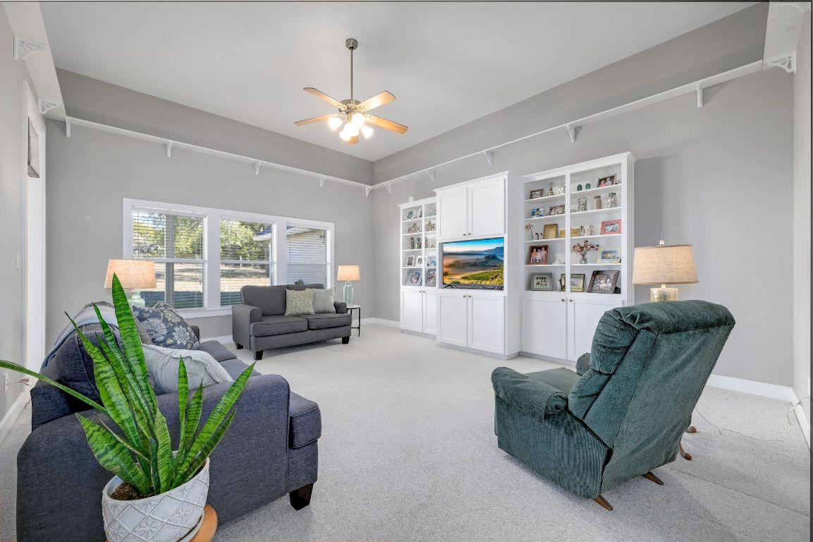 881 Saddle Ridge Drive Wimberley, TX 78676 - Photo 6 of 30 a living room with furniture and a chandelier