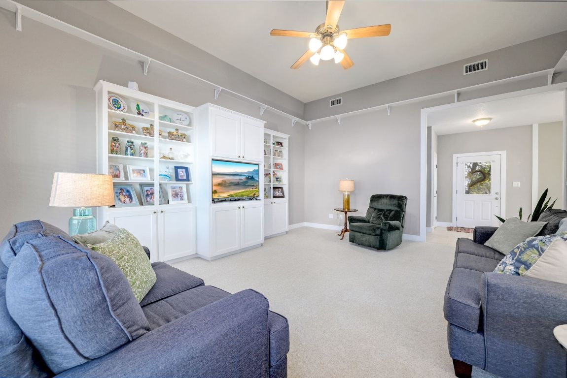 881 Saddle Ridge Drive Wimberley, TX 78676 - Photo 8 of 30 a living room with furniture and a chandelier