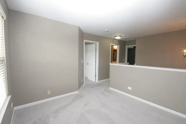 an empty room with windows and entrance