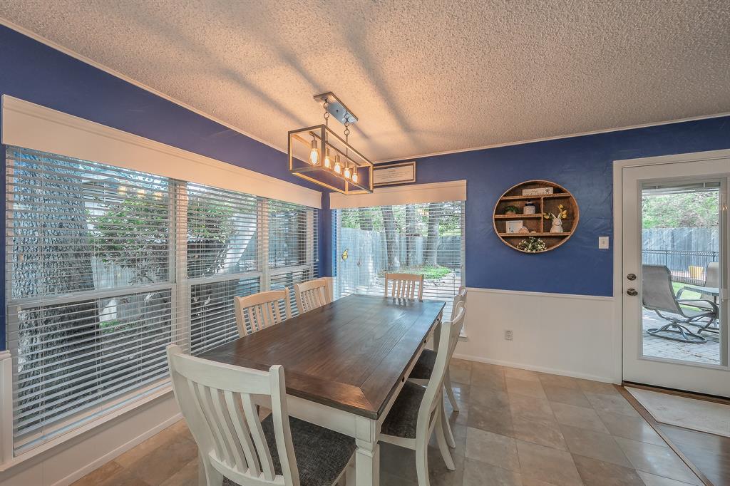 2003 Edgebrook Court Arlington, TX 76015 - Photo 20 of 40 a view of a dining room with furniture a chandelier and wooden floor