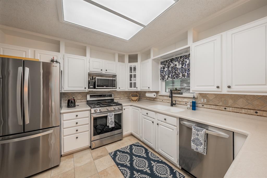2003 Edgebrook Court Arlington, TX 76015 - Photo 21 of 40 a kitchen with stainless steel appliances granite countertop a refrigerator sink and stove