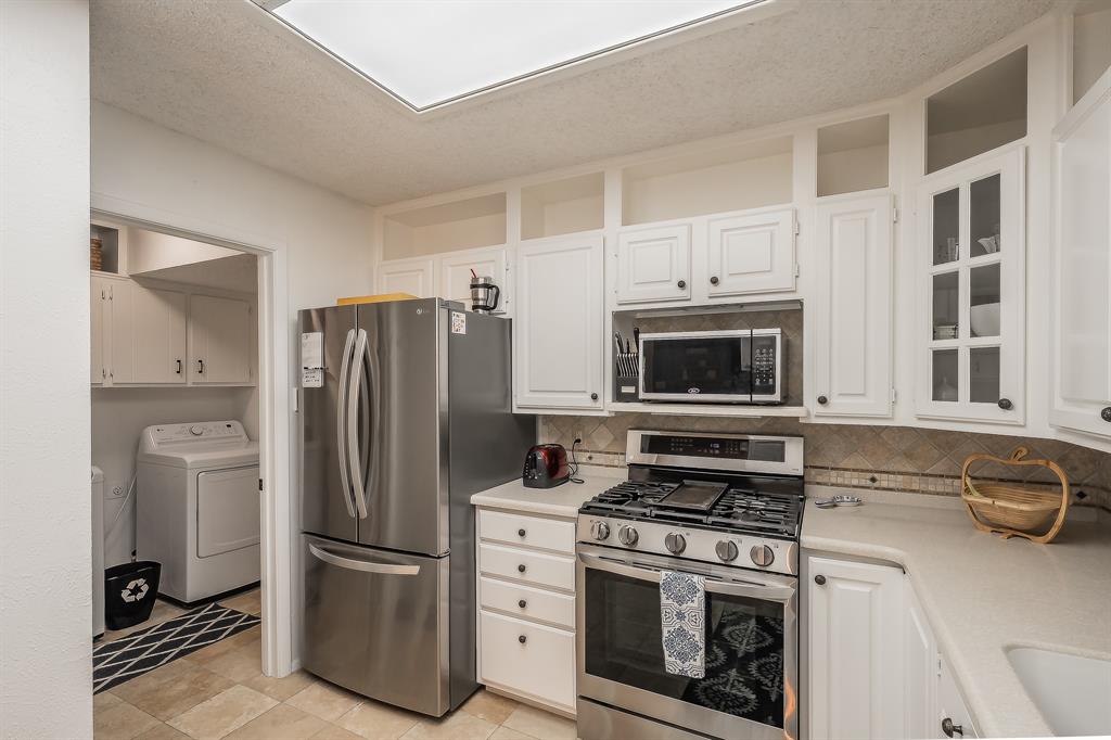 2003 Edgebrook Court Arlington, TX 76015 - Photo 22 of 40 a kitchen with stainless steel appliances a stove a refrigerator and a microwave