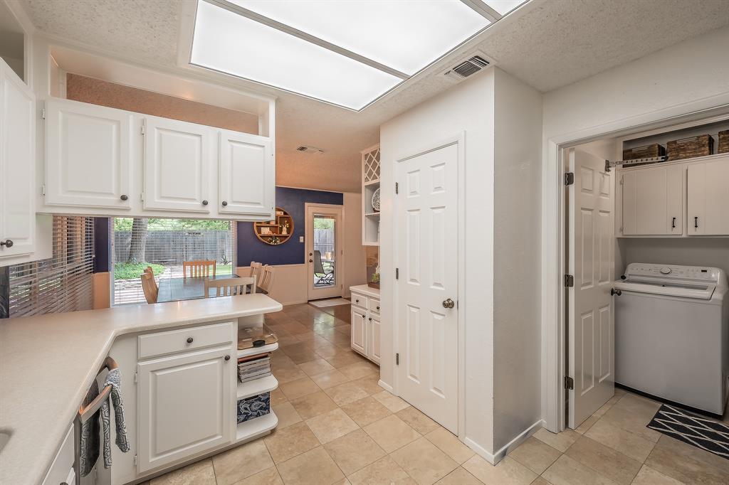 2003 Edgebrook Court Arlington, TX 76015 - Photo 24 of 40 a kitchen with white cabinets and white appliances