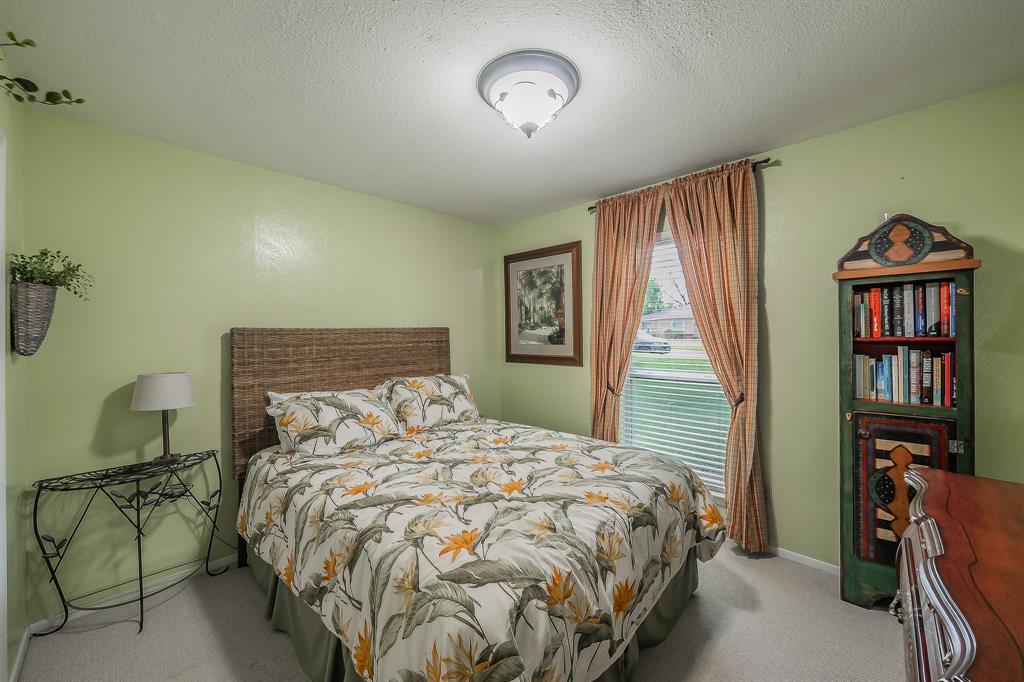 2003 Edgebrook Court Arlington, TX 76015 - Photo 25 of 40 a bed sitting in a bedroom next to a window