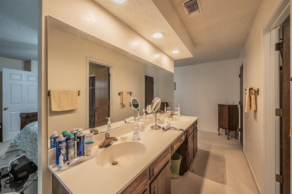 2003 Edgebrook Court Arlington, TX 76015 - Photo 32 of 40 a en suite bathroom with a double vanity sink and a mirror
