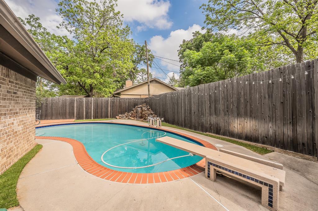 2003 Edgebrook Court Arlington, TX 76015 - Photo 9 of 40 a view of a swimming pool with a patio and wooden fence