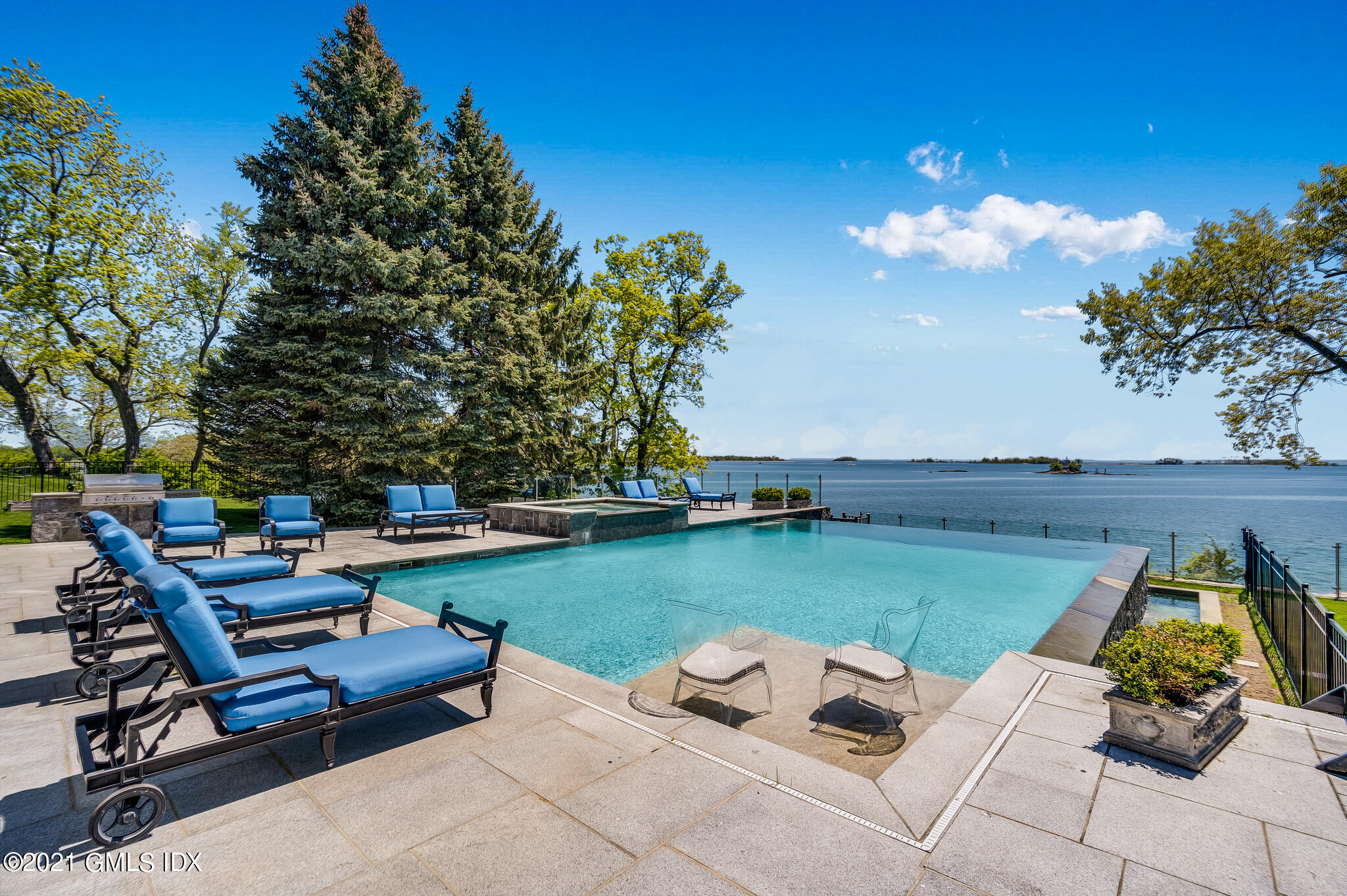 12 Valley Road Norwalk, CT 06854 - Photo 15 of 20 a view of a backyard with lawn chairs potted plants and a large tree