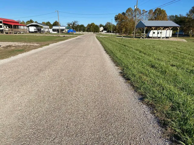 a view of a street with cars on road parking and a building