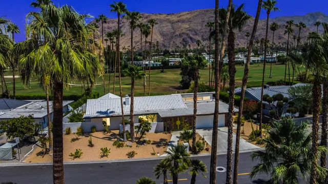 a view of a house with swimming pool and porch with furniture