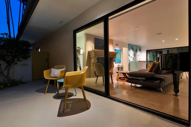 a dining room with furniture a chandelier and wooden floor