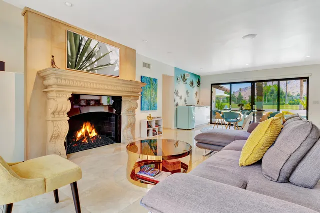 a kitchen with kitchen island granite countertop a sink stove and cabinets