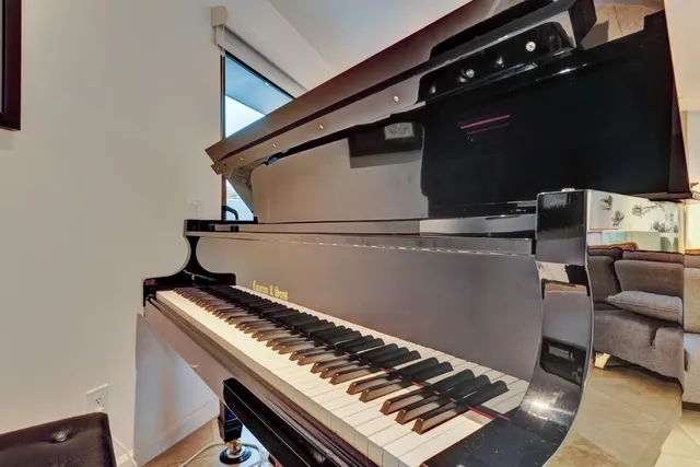 a living room with furniture and a floor to ceiling window