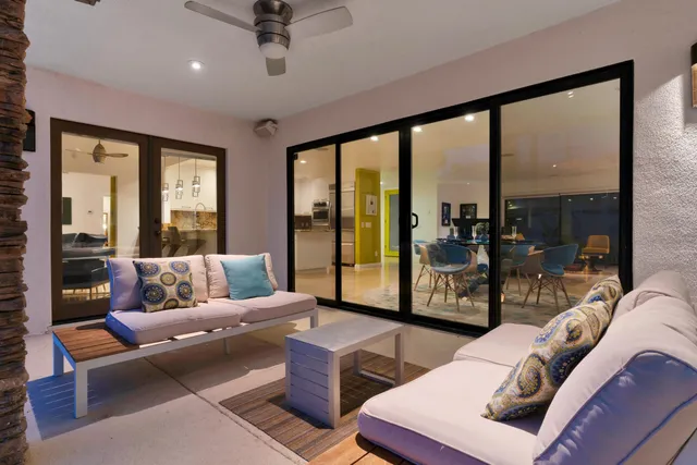 a bedroom with large bed and large windows