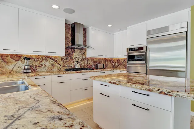 a spacious bedroom with a bed and glass windows