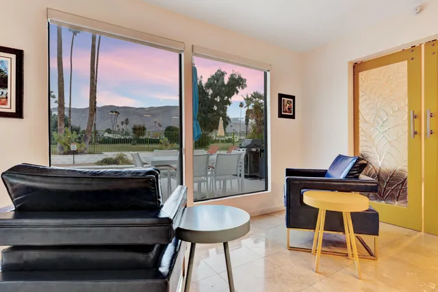 a view of a swimming pool with a lawn chairs