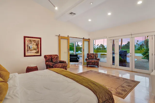 a bathroom with a sink and a large mirror next to a window