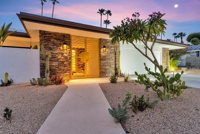 a view of a house with a yard balcony and sitting area