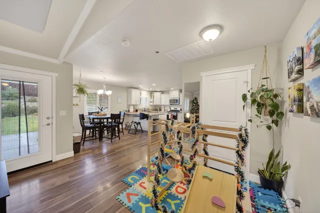 a living room with furniture and wooden floor