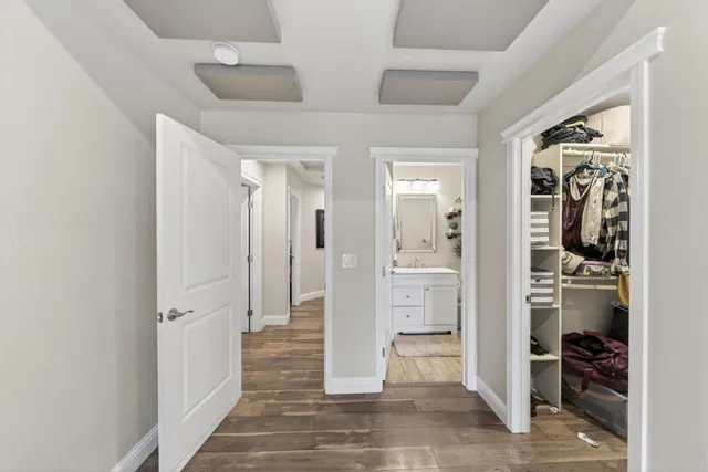 a view of a hallway with white walls and closet