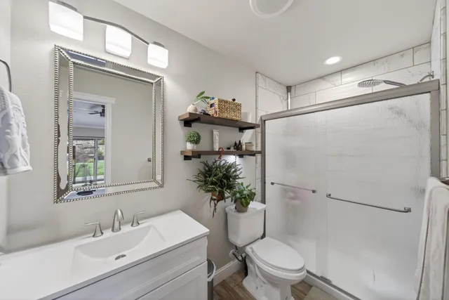 a bathroom with a sink toilet and shower