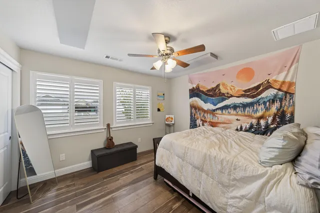 a bedroom with a bed and a chandelier