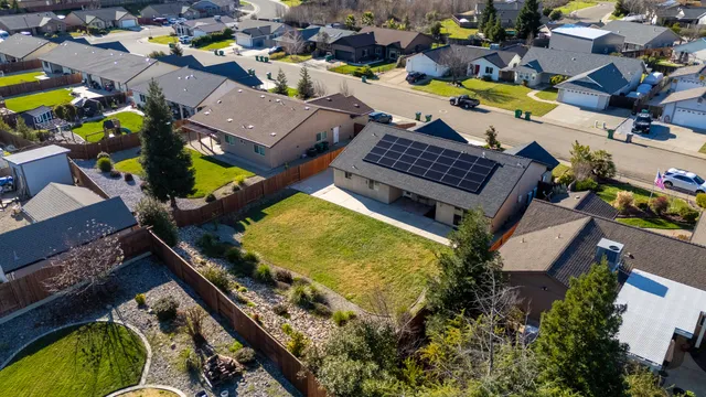 an aerial view of a house with a garden and swimming pool