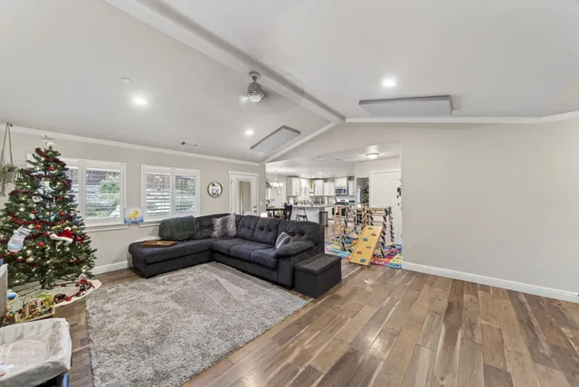 a living room with furniture and flowers