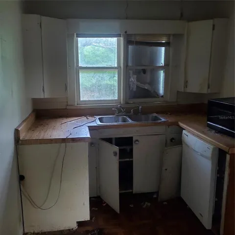 a utility room with sink dryer and washer