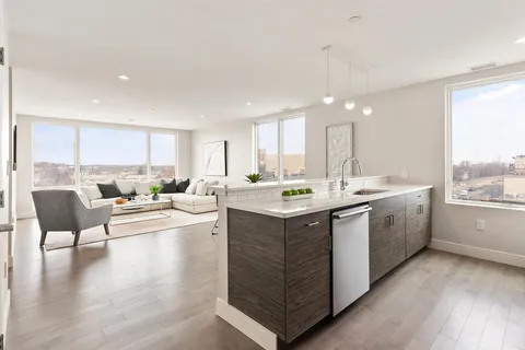 a kitchen with a sink stove and cabinets
