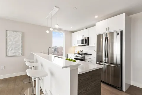 a kitchen with stainless steel appliances a refrigerator sink and microwave
