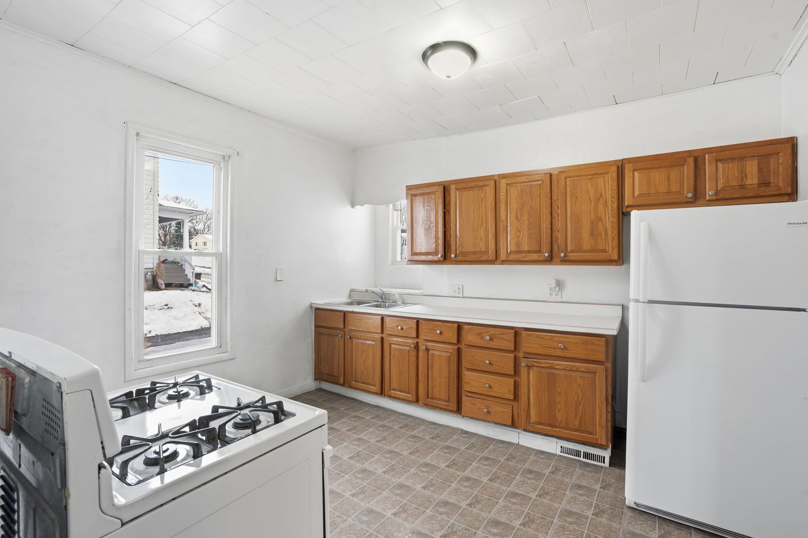 1306 17th Street Moline, IL 61265 - Photo 8 of 14 a kitchen with stainless steel appliances granite countertop a sink stove and refrigerator