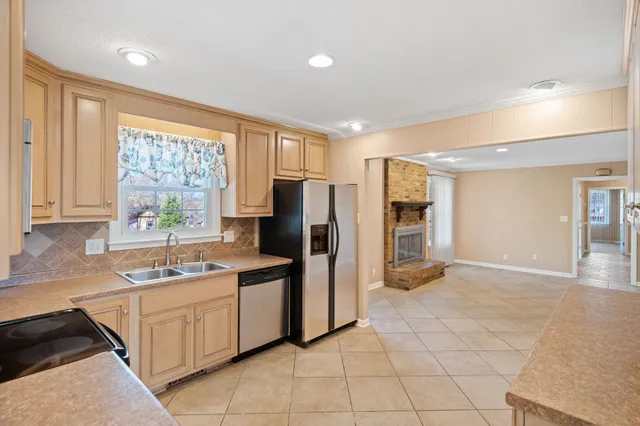 a kitchen with a stove a sink and a refrigerator