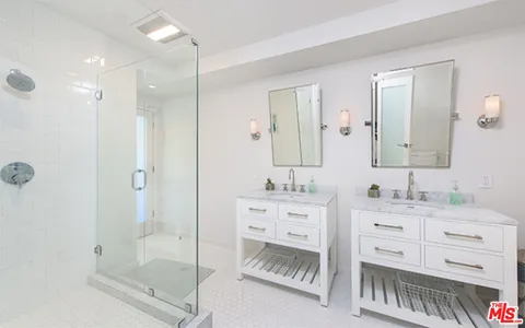 a bathroom with a shower sink and mirror